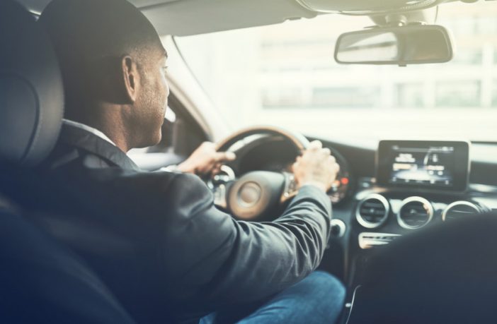 man driving car