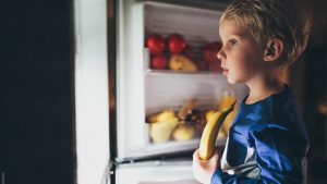 child at fridge