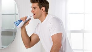 Man using the WP-450 Cordless Plus water flosser