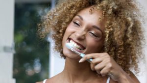 woman brushing teeth
